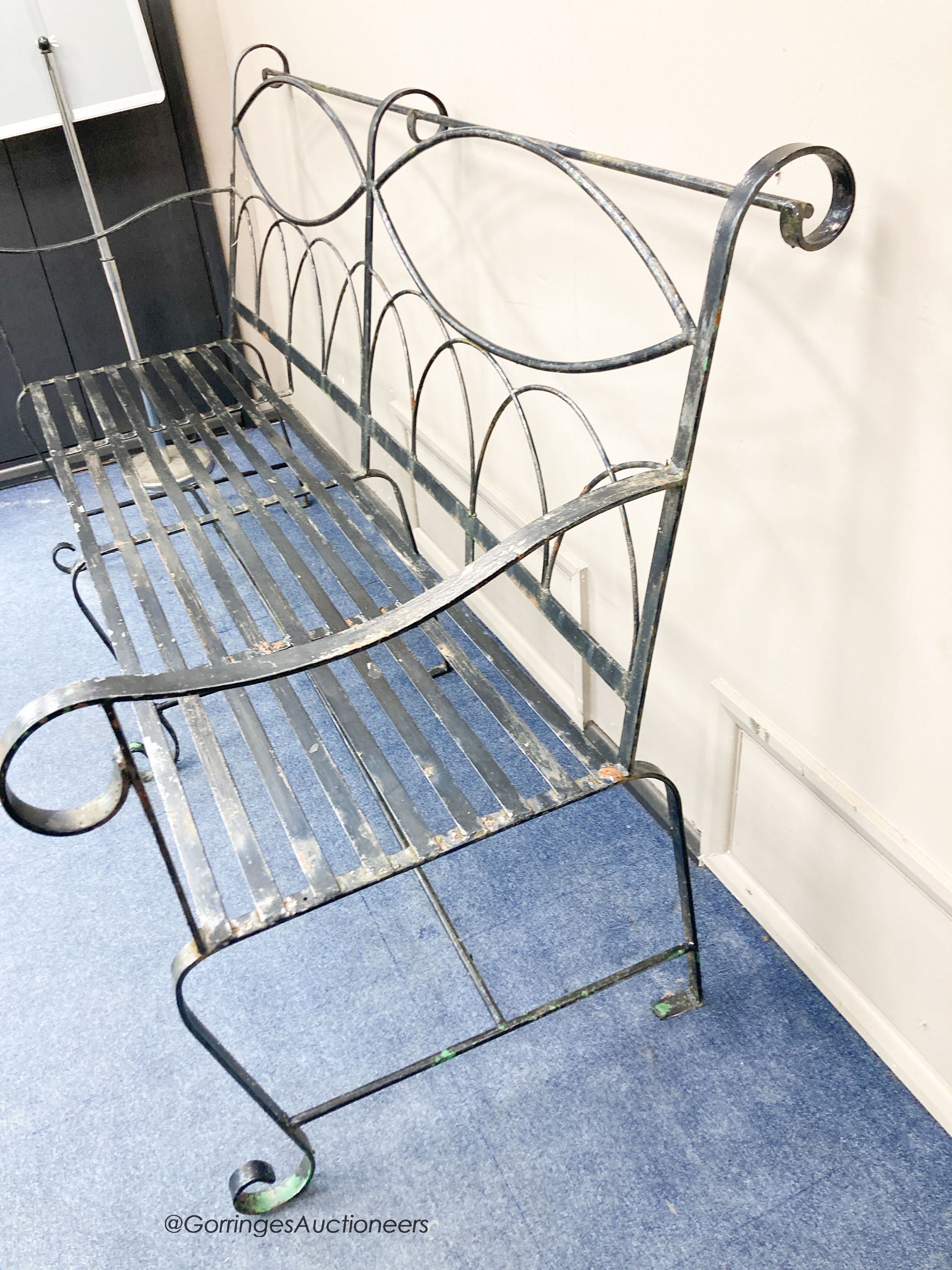 A painted wrought iron garden bench, length 175cm, depth 83cm, height 110cm